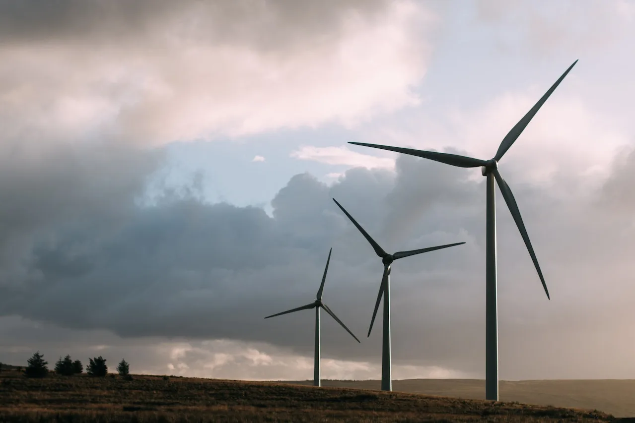 landscape with clouds in the sky and windmills
