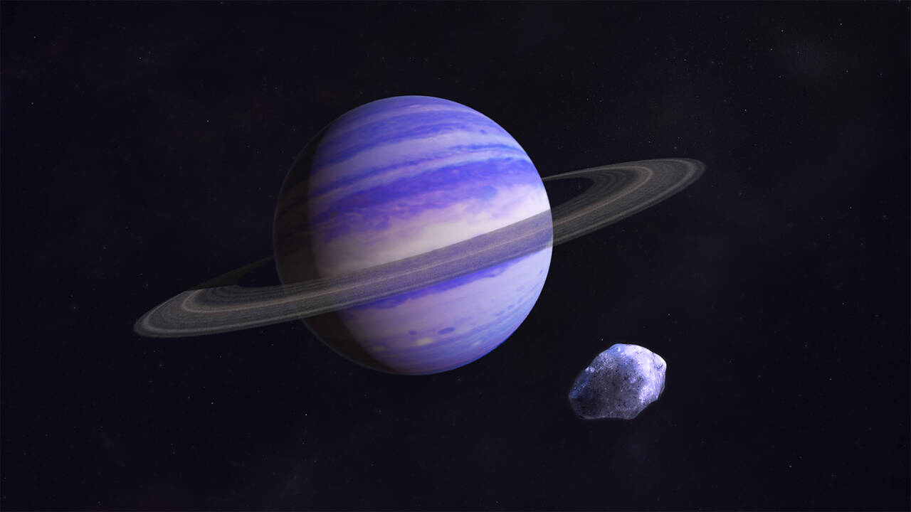 a planet with rings and an asteroid around