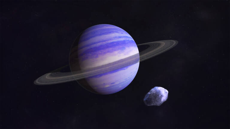 a planet with rings and an asteroid around