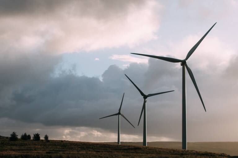 landscape with clouds in the sky and windmills