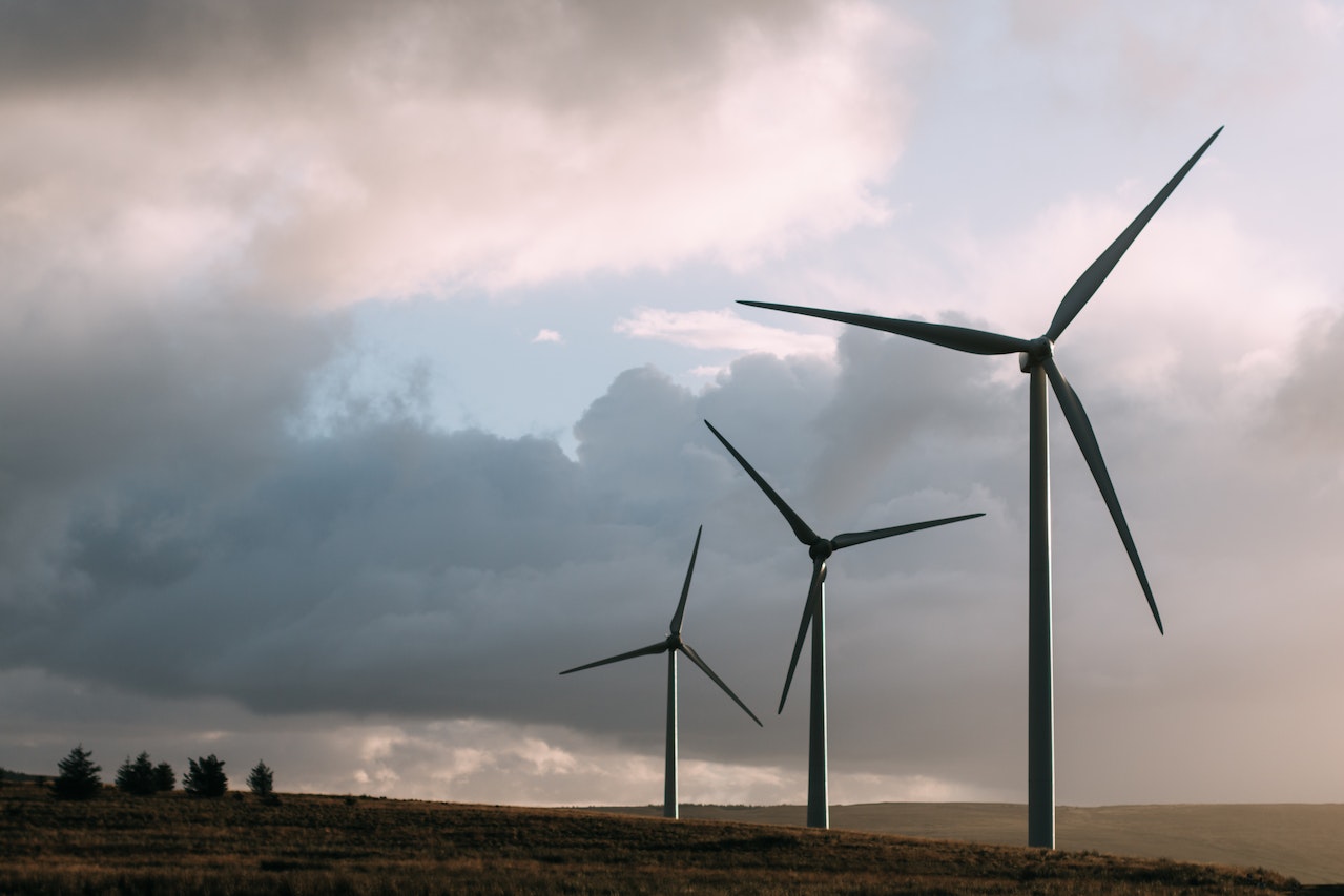 landscape with clouds in the sky and windmills
